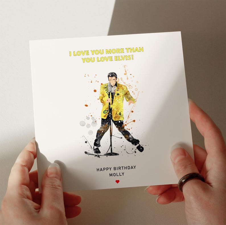 a person holding a card with a picture of a singer