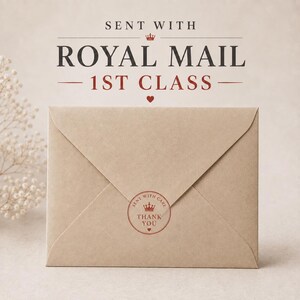 a brown envelope with a stamp and text, sitting on a surface.