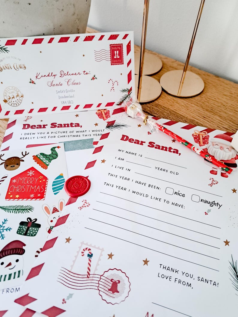 May include: A set of Christmas-themed stationery, including a letter to Santa Claus, an envelope, and a decorative pen. The letter features festive illustrations and the text "Dear Santa." The envelope is addressed to Santa Claus.