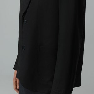 May include: A black blazer with a single button closure and a pocket on the left side.