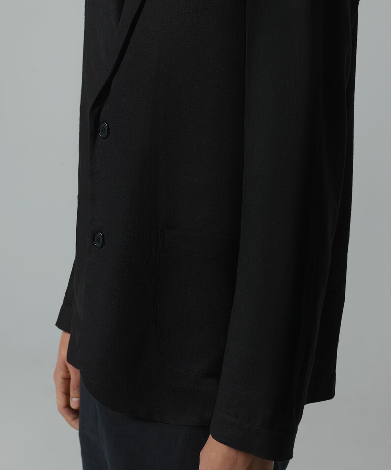 May include: A black blazer with a single button closure and a pocket on the left side.