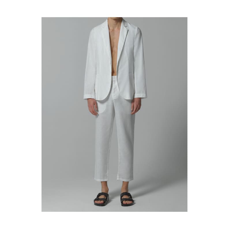 May include: A white linen blazer and matching pants. The blazer has a single button closure and a relaxed fit. The pants have a straight leg and a cropped length.