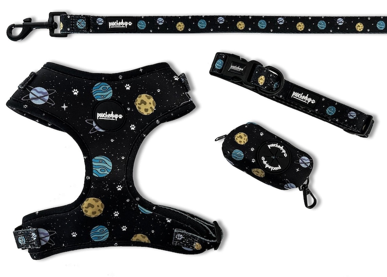 May include: A black dog harness, leash, collar, and poop bag holder with a space-themed print featuring planets, stars, and paw prints. The text "pouchdpo" is printed on the items.