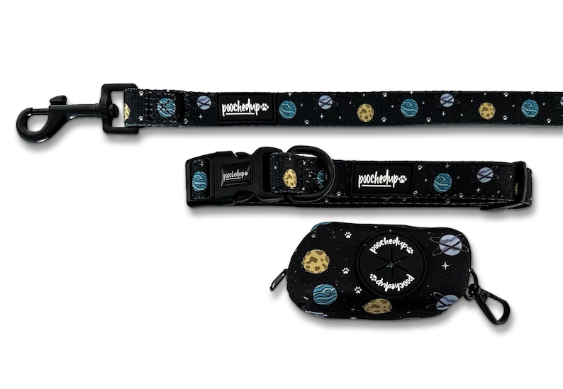 May include: A black dog leash, collar, and poop bag holder with a space-themed print featuring planets, stars, and the text "poochedup" on each item.