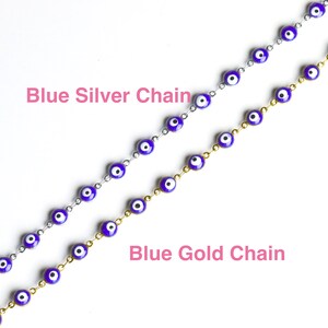 May include: Two necklaces with blue evil eye charms. One necklace has a silver chain and the other has a gold chain. The text "Blue Silver Chain" is above the silver chain necklace and the text "Blue Gold Chain" is below the gold chain necklace.