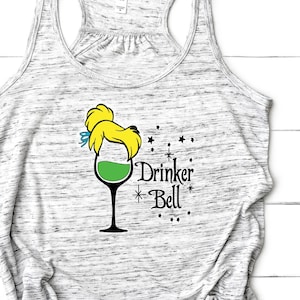 May include: A gray marble-patterned tank top with a graphic of a wine glass filled with green liquid, styled with a blonde hairstyle and a blue bow. The text "Drinker Bell" is printed below the graphic, with stars.
