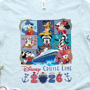 May include: Two light blue t-shirts with a Disney Cruise Line design. The graphic features Disney characters, a cruise ship, and the text "2020". Decorative anchors and ships complete the design.