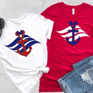 May include: White and red t-shirts featuring a nautical anchor design, alongside denim shorts and a Minnie Mouse ear headband. The anchor is red with a blue outline and a Mickey Mouse head.