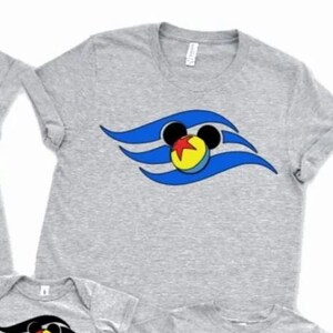 May include: A set of grey t-shirts and a onesie, each displaying a design with Mickey Mouse ears, a yellow ball, and red, blue, and black wave patterns. The shirts are in different sizes.