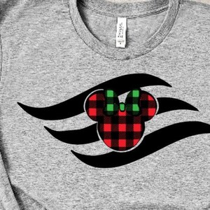 May include: A grey t-shirt featuring a black and red Mickey Mouse head design. The Mickey Mouse head is wearing a green bow and has a red and black buffalo plaid pattern.