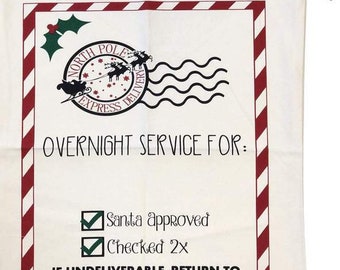 Pode incluir: Um saco de presente de Natal branco com fecho de cordão vermelho. A bolsa apresenta um design retangular com uma borda listrada vermelha e branca. O design inclui o texto "OVERNIGHT SERVICE FOR:" e "SANTA CLAUS, THE NORTH POLE".