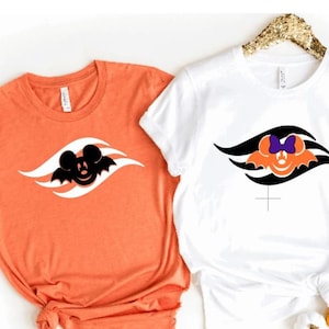May include: Three t-shirts with a Halloween-themed design featuring a Mickey Mouse head with bat wings and a Disney Cruise Line logo. The shirts are orange, white, and black.
