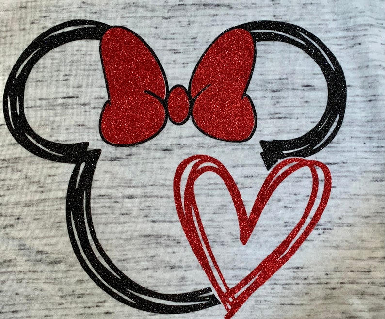 May include: A black and white outline of Mickey Mouse's head with a red glitter bow and a red glitter heart.