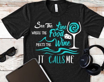 May include: A black t-shirt with a white graphic that says "See the line where the food meets the wine it calls me". The graphic also includes a wine glass with a swirl of liquid and a piece of cheese.