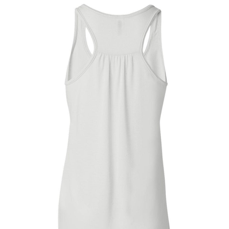 May include: White sleeveless tank top with a scoop neck and racerback style.