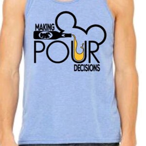 May include: Light blue tank top with the text "MAKING POUR DECISIONS" in black. The design includes a bottle pouring liquid into a Mickey Mouse-shaped outline. The tank top is worn with dark blue jeans.