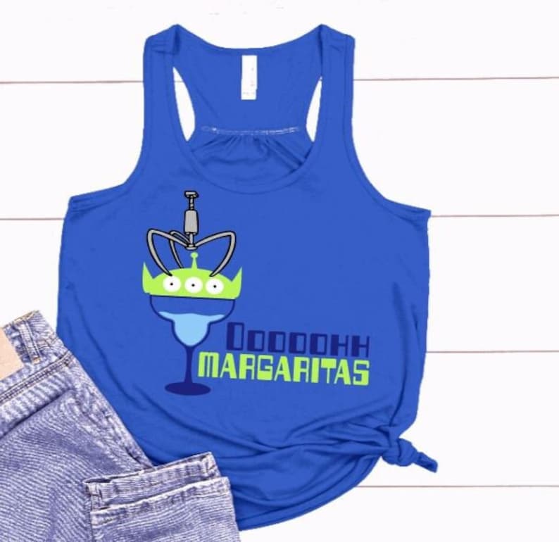 May include: A royal blue tank top with a green alien character holding a margarita glass. The text "Oooooooooh Margaritas" is printed on the shirt.