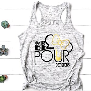 May include: A gray marble-patterned tank top with the phrase "MAKING POUR DECISIONS" in black and gold lettering. The design incorporates a wine bottle, a bow, and a wine glass.