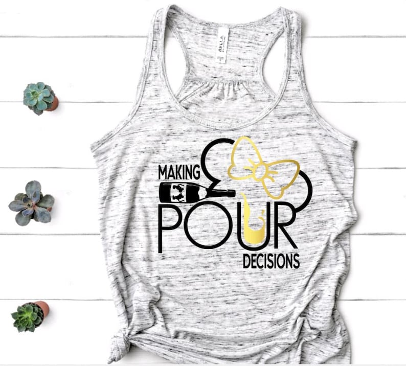May include: A gray marble-patterned tank top with the phrase "MAKING POUR DECISIONS" in black and gold lettering. The design incorporates a wine bottle, a bow, and a wine glass.