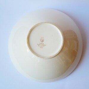 May include: White ceramic bowl with a gold rim and a gold stamp on the bottom that reads "Made in Western Germany, Bavaria, 2243".