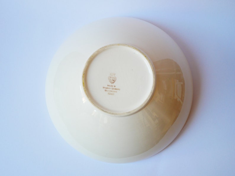 May include: White ceramic bowl with a gold rim and a gold stamp on the bottom that reads "Made in Western Germany, Bavaria, 2243".