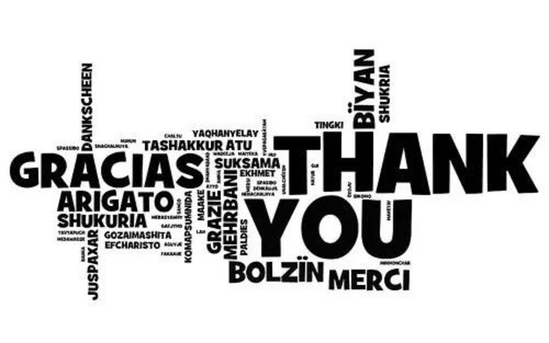 May include: A black and white graphic design featuring the words "Thank You" in bold letters, surrounded by various international translations like "Gracias" and "Merci". The design is a word cloud.
