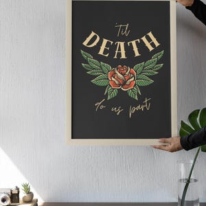 May include: A black and white framed print with a vintage style illustration of a red rose with green leaves and the text "Til Death Do Us Part".
