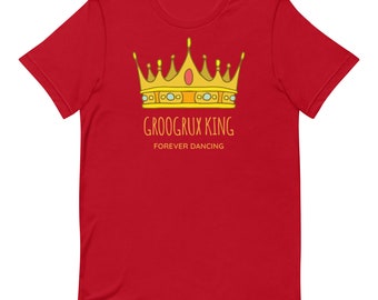 May include: Red t-shirt with a yellow crown and the text "Groogrux King Forever Dancing" printed on the front.