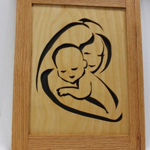 Hand crafted mother and child cut out in solid oak frame