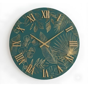 May include: A round wall clock with a dark teal face featuring gold-colored line art of various tropical leaves. The clock has gold-colored hour and minute hands and raised gold-colored Roman numerals positioned around the perimeter of the face.