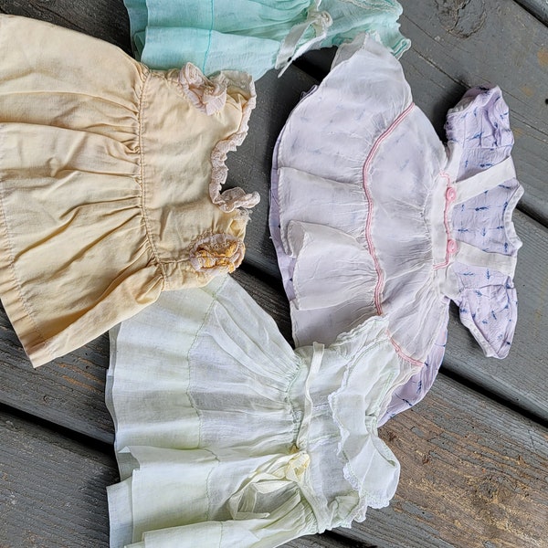 Four Vintage Doll Dresses, One Lavender Top and White Apron with Pink Buttons, One White, One Green, One Peach, 7-9 inches long (2693)
