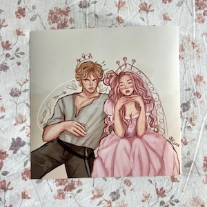 May include: A square print featuring a romantic illustration of a couple. The man has blond hair and wears a gray shirt and black pants. The woman has pink hair and a pink dress. Both have crowns. The background is white with a floral design.