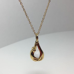 Delicate little hands and crystal ball pendant by Charles Jourdan
