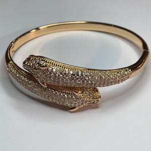 Beautiful bangle bracelet with 2 sparkling panthers