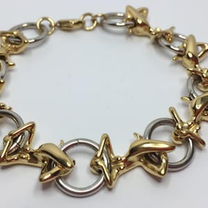 Superb two-tone bracelet with acrobats and hoops by Charles Jourdan
