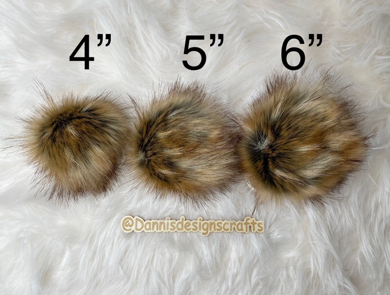 May include: Three faux fur pom poms in brown and beige, measuring 4 inches, 5 inches, and 6 inches in diameter.