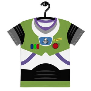 May include: Green, white, and black t-shirt with a cartoon image of Buzz Lightyear from the Toy Story movie franchise. The shirt has a purple collar and a yellow patch that says "LIGHTYEAR".