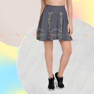 May include: A gray skater skirt with a white skeleton print. The skirt is knee-length and has a flared silhouette.
