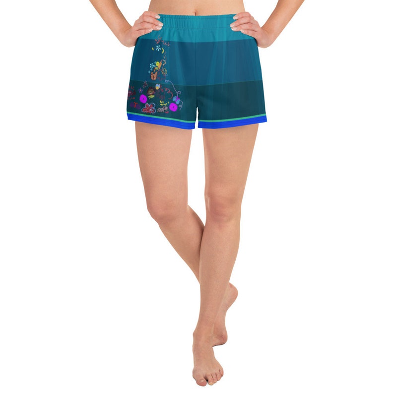 May include: A pair of blue athletic shorts with a colorful floral print and a blue, green, and white ombre design.