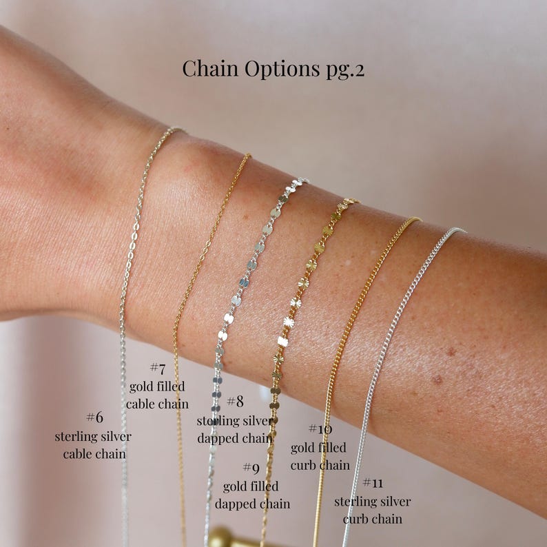 May include: A selection of delicate necklaces in gold and silver tones. The image displays six different chain styles: cable, dapped, and curb chains. Text on the image reads "Chain Options pg.2" and identifies each chain with a number and description.