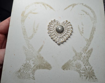 Handprinted Christmas card decorated with crochet heart applique