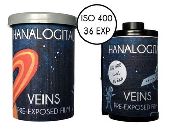 May include: A cylindrical container and a 35mm film canister labeled HANALOGITAL VEINS PRE-EXPOSED FILM. Both items feature a dark blue space-themed design with stars, a planet, and an astronaut. The text ISO 400 36 EXP is clearly visible on both.