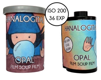 May include: A cylindrical container and a 35mm film canister labeled HANALOGITAL OPAL FILM SOUP FILM. The packaging features an illustration of a character blowing a blue bubble. Text on the items includes ISO 200 and 36 EXP, indicating the film speed and exposure count for this photographic product.
