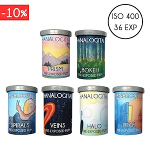 May include: Six cylindrical canisters of Hanalogital pre-exposed film with grey lids. Each canister features unique illustrations labelled Prism, Bokeh, Spirals, Veins, Halo, and Leak. The top right corner displays ISO 400 36 EXP in a black circle.