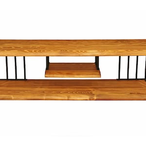 May include: A wooden TV stand with a black metal frame. The stand has two shelves and a natural wood finish.