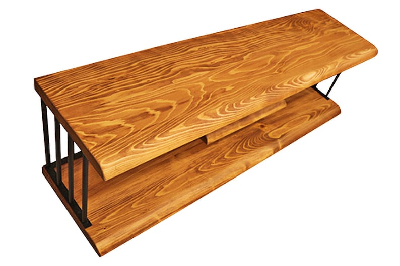 May include: A wooden TV stand with a natural wood finish and black metal legs. The stand has two shelves.