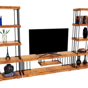 May include: A wooden TV stand with black metal accents and shelves. The stand has three shelves on each side and a lower shelf for a TV. The shelves are filled with books, vases, and decorative items.