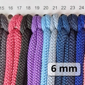 May include: A colour chart of 6 mm cord in various colours, including red, black, purple, blue, and grey. The chart is labelled with numbers 15 through 24. The text "6 mm" is printed on a white label.
