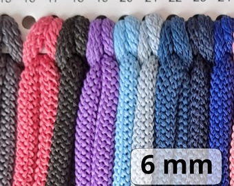 May include: A color chart of 6 mm cord in various colors, including red, black, purple, blue, and grey. The chart is labeled with numbers 15 through 24. The text "6 mm" is printed on a white label.