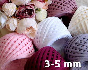 May include: Assortment of chunky yarn in various colors, including pink, white, burgundy, and gray. The yarn is 3-5 mm thick.